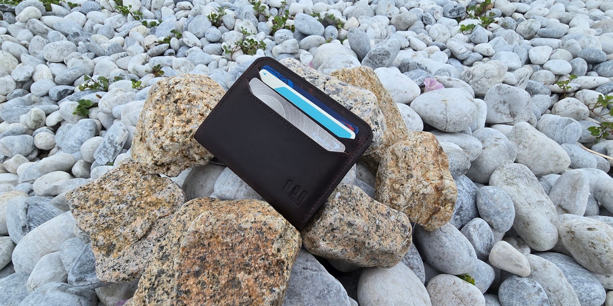Brown leather wallet on top of rocks